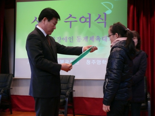 교장선생님께서 이인혜 학생에게 상장을 수여해 주는 장면입니다